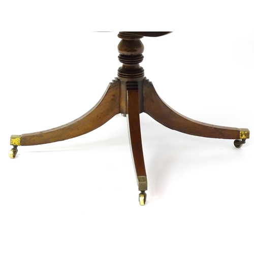 1456 - A 19thC rosewood dining table / breakfast table with a reeded tilt top above a turned pedestal and f... 