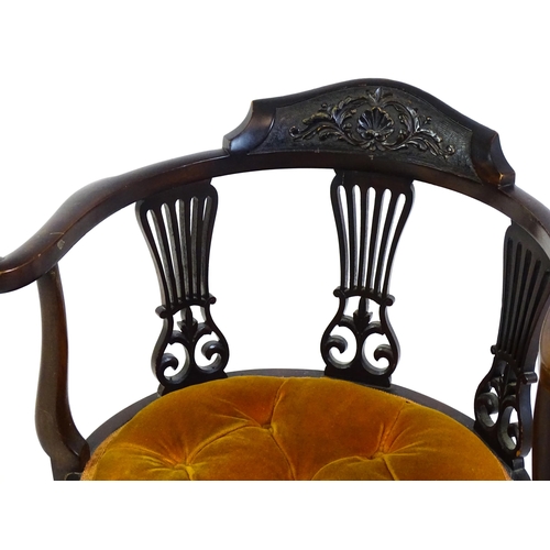 1457 - An early 20thC mahogany bow back chair with a carved cresting rail above three pierced, fanned back ... 