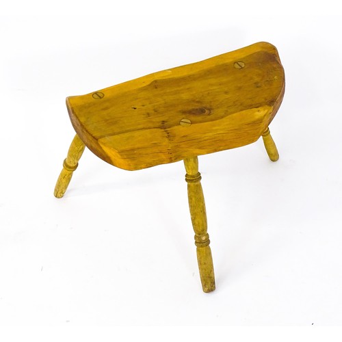 1458 - A mid / late 20th stool , with a yew wood seat raised on three turned tapering legs. 21