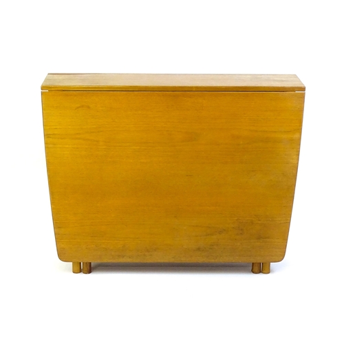 1464 - Vintage / Retro / Mid Century: A teak drop flap table by McIntosh raised on turned tapering legs. 10... 