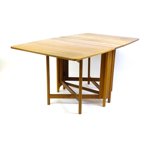 1464 - Vintage / Retro / Mid Century: A teak drop flap table by McIntosh raised on turned tapering legs. 10... 