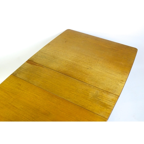 1464 - Vintage / Retro / Mid Century: A teak drop flap table by McIntosh raised on turned tapering legs. 10... 