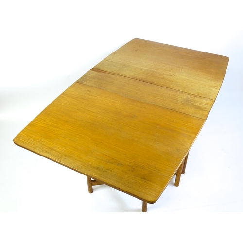 1464 - Vintage / Retro / Mid Century: A teak drop flap table by McIntosh raised on turned tapering legs. 10... 