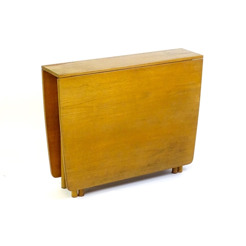 1464 - Vintage / Retro / Mid Century: A teak drop flap table by McIntosh raised on turned tapering legs. 10... 