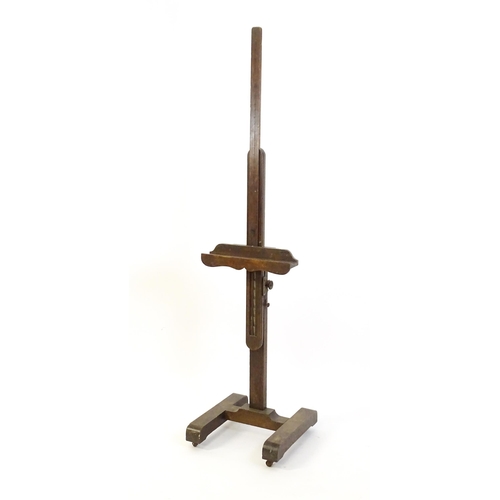 1851 - A 20thC oak artist's floor standing adjustable easel. Approx 67