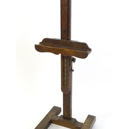 1851 - A 20thC oak artist's floor standing adjustable easel. Approx 67