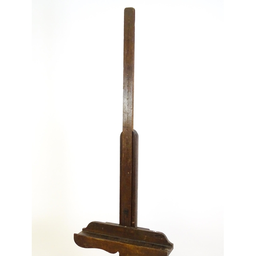 1851 - A 20thC oak artist's floor standing adjustable easel. Approx 67