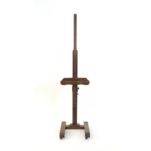 1851 - A 20thC oak artist's floor standing adjustable easel. Approx 67