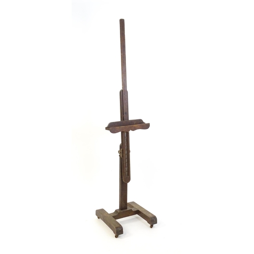 1851 - A 20thC oak artist's floor standing adjustable easel. Approx 67