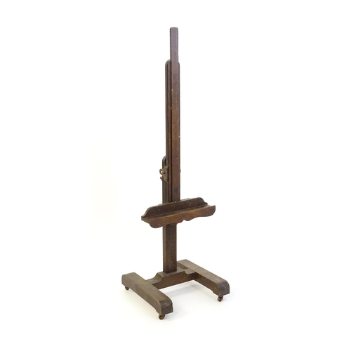 1851 - A 20thC oak artist's floor standing adjustable easel. Approx 67