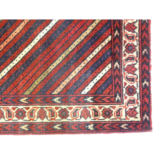 1276 - Carpet / Rug : A South west Persian Lori rug with diagonal banded detail within a  floral and geomet... 