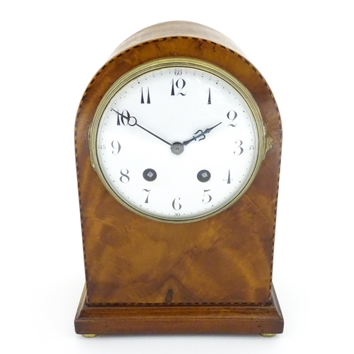 1292 - A 19thC arch top mantel clock, the flame mahogany case with boxwood and ebony stringing, enamelled d... 