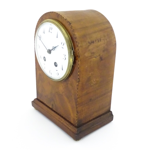 1292 - A 19thC arch top mantel clock, the flame mahogany case with boxwood and ebony stringing, enamelled d... 