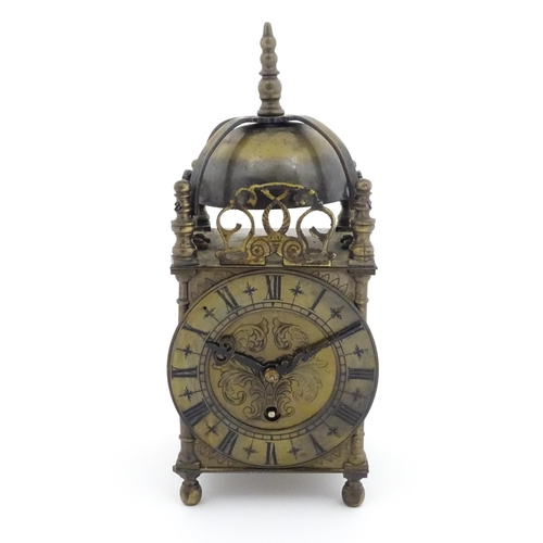 1295 - A 20thC brass cased lantern clock, the movement marked Empire. Approx 10