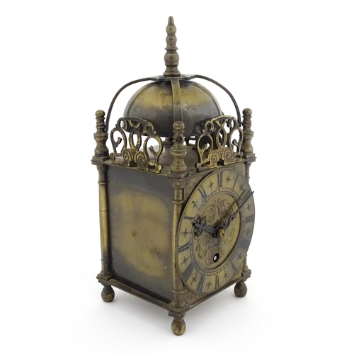 1295 - A 20thC brass cased lantern clock, the movement marked Empire. Approx 10