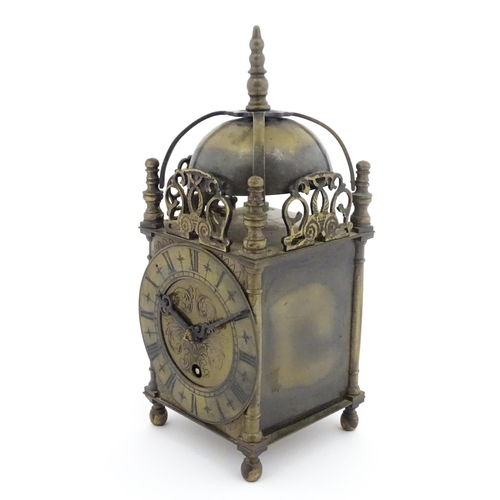 1295 - A 20thC brass cased lantern clock, the movement marked Empire. Approx 10