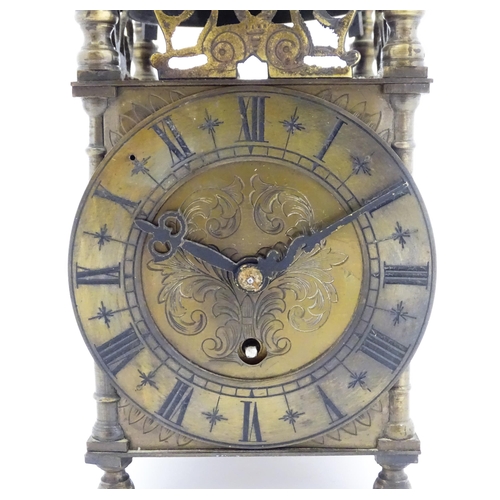 1295 - A 20thC brass cased lantern clock, the movement marked Empire. Approx 10