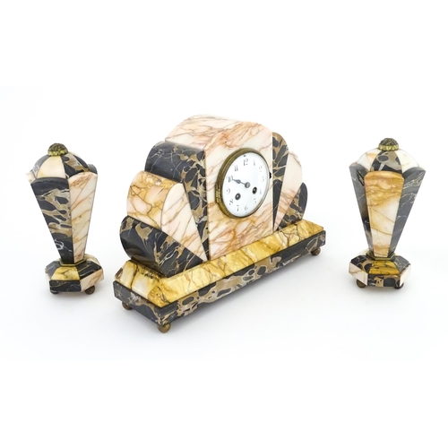 1303 - A French Art Deco marble cased clock and garnitures. The clock with white enamel dial, the 8-day mov... 