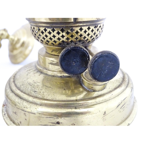 1313 - A pair of early 20thC oil lamps, the adjustable wall mounts supporting duplex burners, each approx 1... 