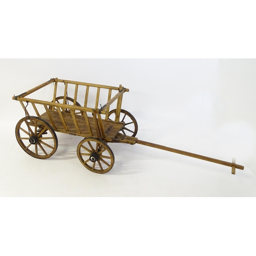 1321 - A 19thC wooden dog cart / hand cart with four wheels. Approx 47