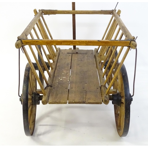 1321 - A 19thC wooden dog cart / hand cart with four wheels. Approx 47