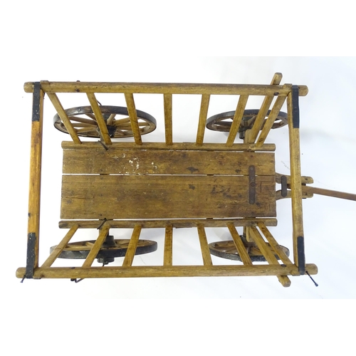 1321 - A 19thC wooden dog cart / hand cart with four wheels. Approx 47