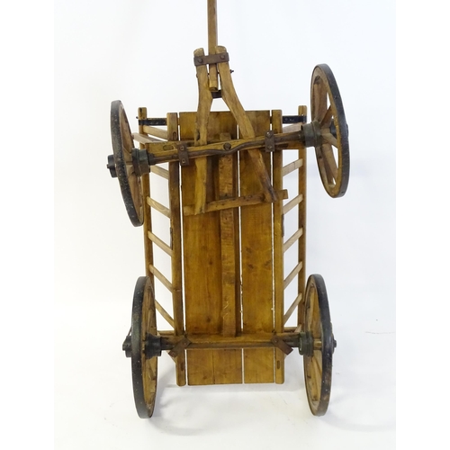 1321 - A 19thC wooden dog cart / hand cart with four wheels. Approx 47