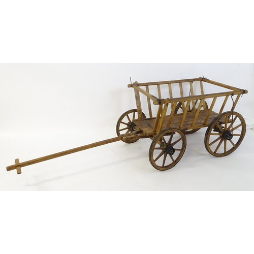 1321 - A 19thC wooden dog cart / hand cart with four wheels. Approx 47