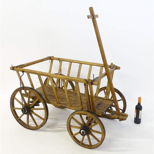 1321 - A 19thC wooden dog cart / hand cart with four wheels. Approx 47