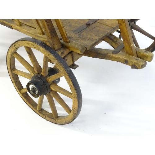 1321 - A 19thC wooden dog cart / hand cart with four wheels. Approx 47