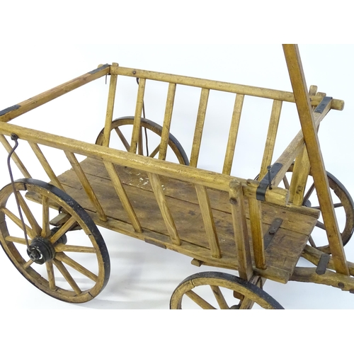 1321 - A 19thC wooden dog cart / hand cart with four wheels. Approx 47