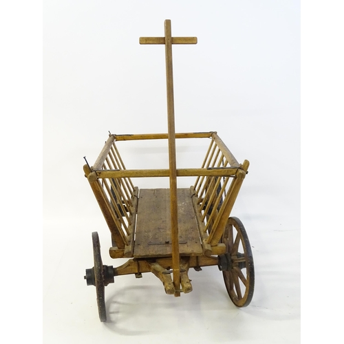 1321 - A 19thC wooden dog cart / hand cart with four wheels. Approx 47