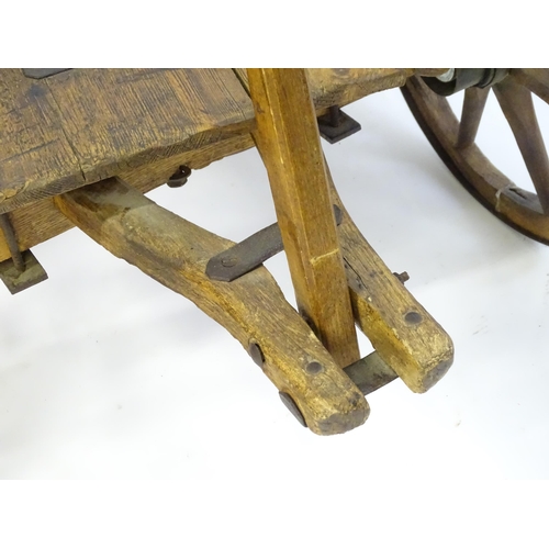 1321 - A 19thC wooden dog cart / hand cart with four wheels. Approx 47