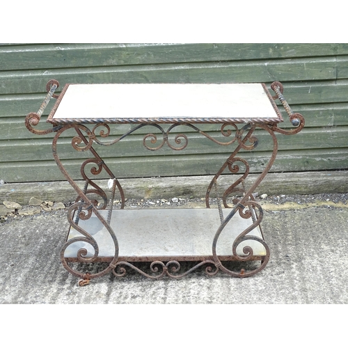 1323 - A mid 20thC wrought iron garden / patio table, the scrolled frame supporting two inset stone tiers, ... 