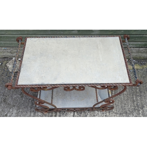 1323 - A mid 20thC wrought iron garden / patio table, the scrolled frame supporting two inset stone tiers, ... 