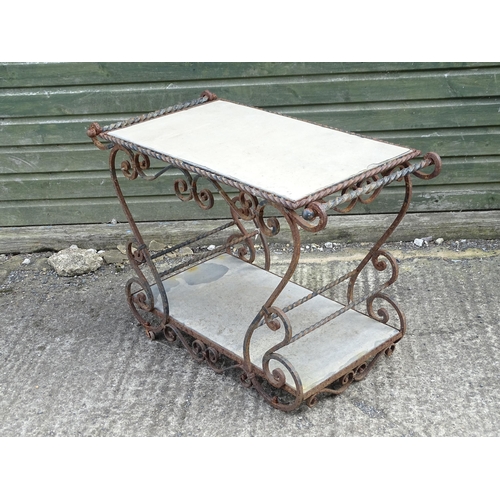 1323 - A mid 20thC wrought iron garden / patio table, the scrolled frame supporting two inset stone tiers, ... 