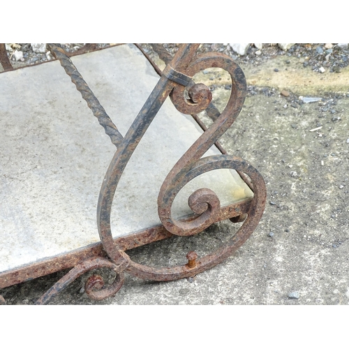 1323 - A mid 20thC wrought iron garden / patio table, the scrolled frame supporting two inset stone tiers, ... 