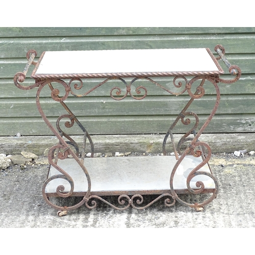 1323 - A mid 20thC wrought iron garden / patio table, the scrolled frame supporting two inset stone tiers, ... 