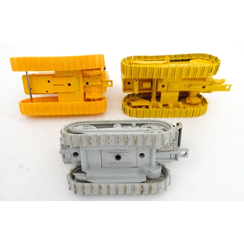 854 - Toys: An Ertl scale model John Deere 1010 Crawler Tractor in yellow, and an Ertl Caterpillar Tractor... 