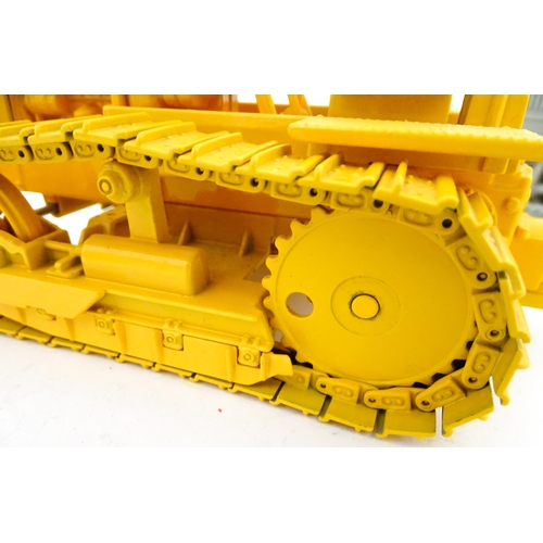 854 - Toys: An Ertl scale model John Deere 1010 Crawler Tractor in yellow, and an Ertl Caterpillar Tractor... 