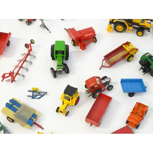 857 - Toys: A quantity of assorted Britains farmyard die cast and plastic toys / models to include tractor... 