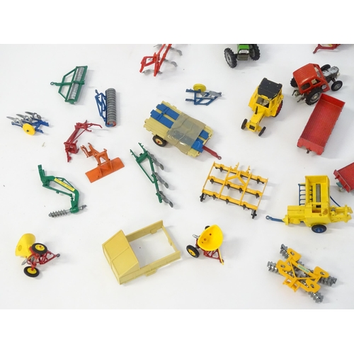 857 - Toys: A quantity of assorted Britains farmyard die cast and plastic toys / models to include tractor... 