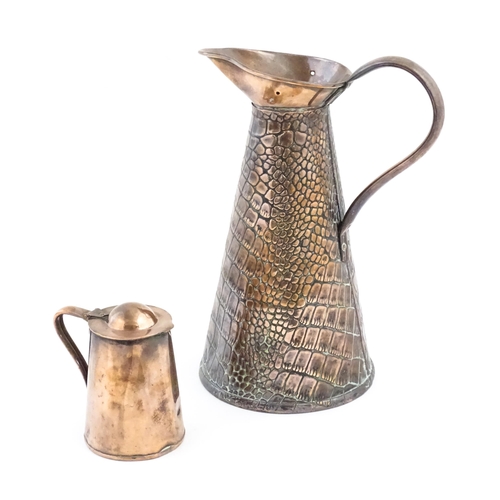 1001 - Two Arts and Crafts copper jugs by Joseph Sankey & Son comprising a tapering ewer with crocodile ski... 