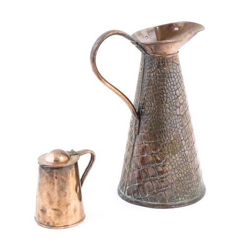 1001 - Two Arts and Crafts copper jugs by Joseph Sankey & Son comprising a tapering ewer with crocodile ski... 