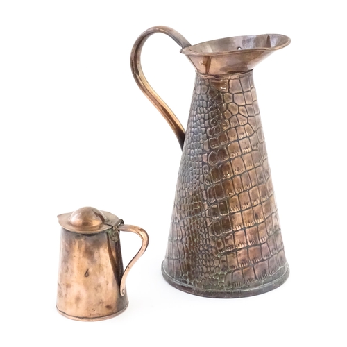 1001 - Two Arts and Crafts copper jugs by Joseph Sankey & Son comprising a tapering ewer with crocodile ski... 