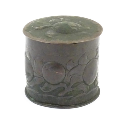 1004 - An Arts and crafts copper tea caddy with embossed fruit decoration. Marked Newlyn under. Approx. 4 1... 