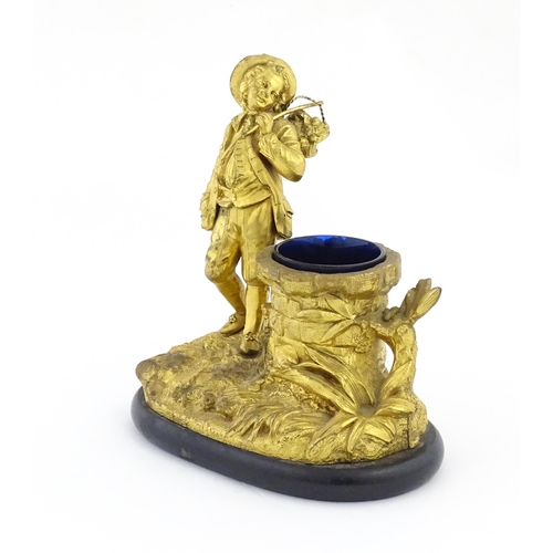 1014 - A late 19th / early 20thC gilt bronze figural spill vase modelled as a young man holding a basket of... 