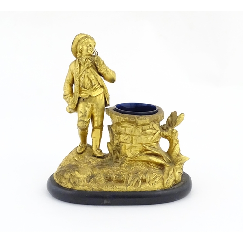 1014 - A late 19th / early 20thC gilt bronze figural spill vase modelled as a young man holding a basket of... 