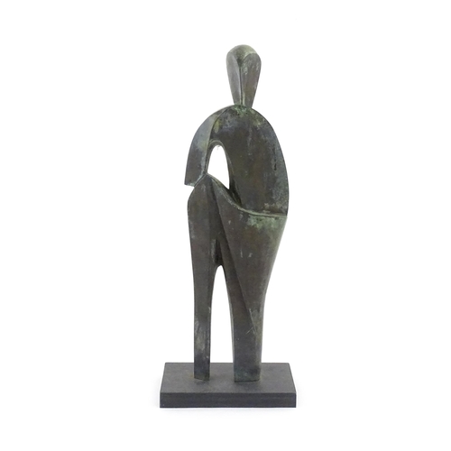 1020 - A 20thC cast bronze sculpture depicting a stylised standing figure. In the manner of JD Hansen. Appr... 