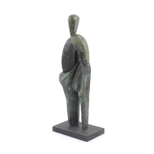 1020 - A 20thC cast bronze sculpture depicting a stylised standing figure. In the manner of JD Hansen. Appr... 